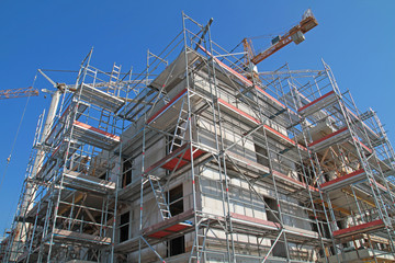 Multi-storey building surrounded by scaffolding during construction