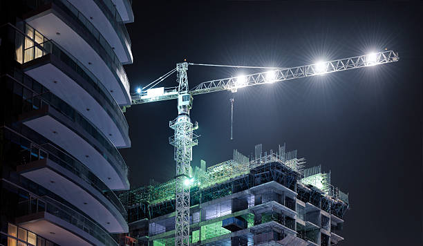 Night-time construction crane above a building under construction