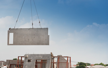 Large precast wall panel being lifted into position
