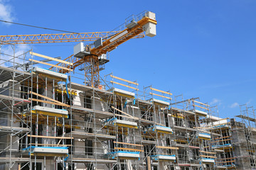 Multi-storey structural construction with crane and scaffolding